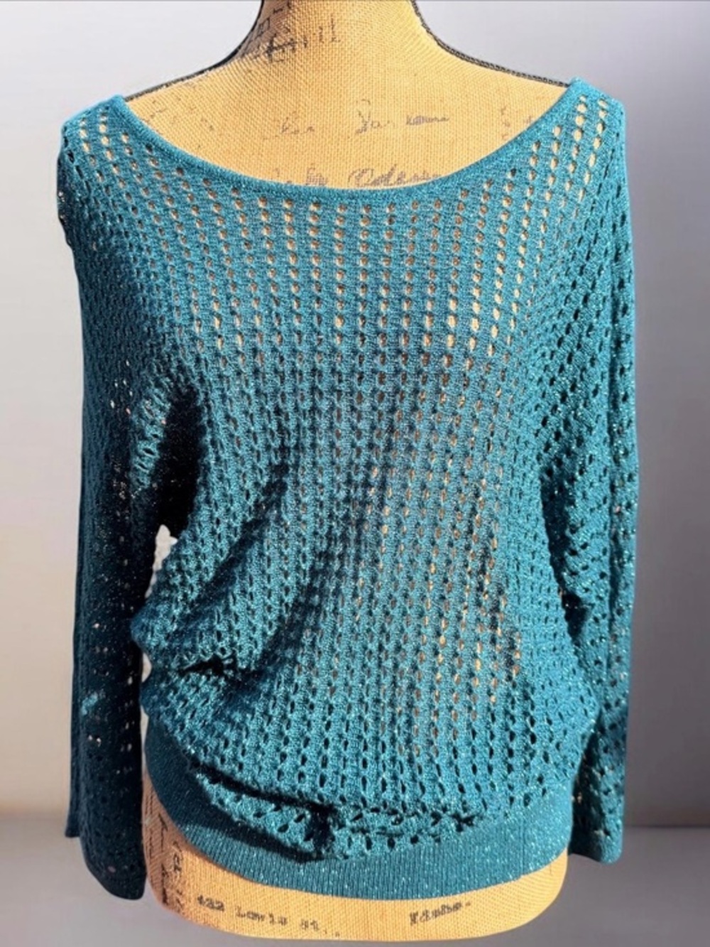 Express green open-weave sweater features a bateau neck and long sleeves